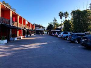 a street with cars parked in a parking lot at Central Jetty Motel in The Entrance
