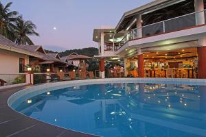 a large swimming pool in front of a house at The Nest El Nido Beach Resort in El Nido