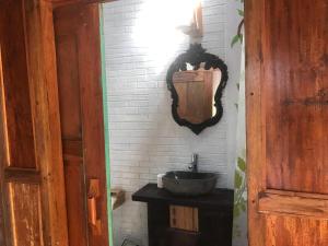 a bathroom with a sink and a mirror on the wall at Diana's Homestay in Banyuwangi