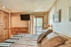 a bedroom with a large bed and a television at Snowfire 209B in Angel Fire