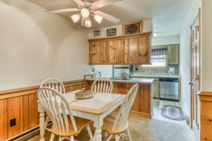 a kitchen with a table and chairs and a ceiling fan at Snowfire 209B in Angel Fire