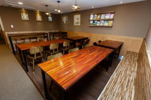 a dining room with wooden tables and chairs at Step Inn Myeongdong 1 in Seoul