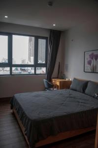 Postel nebo postele na pokoji v ubytování Nếp Apartment Hotel
