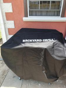 a black tarp with the words backyard grill on it at Breezy Apts in Saint Philip