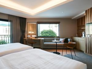 Postel nebo postele na pokoji v ubytování The Suites Hotel Jeju