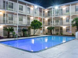 a large swimming pool in front of a building at Studio 6-San Antonio, TX - Lackland AFB in San Antonio