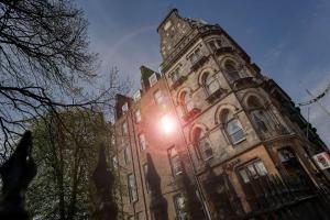 a building with the sun shining on it at Best Western Queens Hotel in Dundee