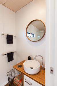 a bathroom with a sink and a mirror at Romantic Vineyard getaway in Waipara