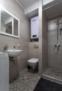 a bathroom with a sink and a toilet and a shower at Apartment on Peremohy Ave 20 in Kyiv