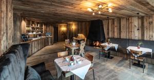 an overhead view of a restaurant with tables and a fireplace at Chalet Cogolara in Colfosco