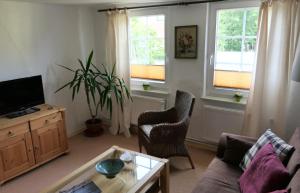 a living room with a couch and a table at Kapitänshaus in Strandnähe in Prerow in Prerow