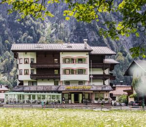 a large building in front of a mountain at Mauracherhof in Maurach