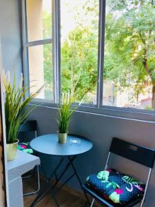 a table and chairs in front of a window at Legnica Apartament 42m2 Delux 4 in Legnica