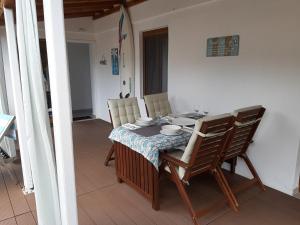 a dining room table and chairs with a table and chairsktop at Zuzanna Apartment in Patitiri