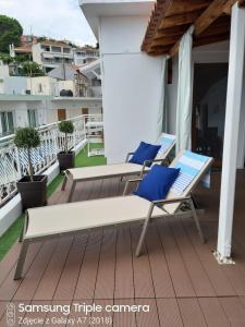 two chairs and a bench on a balcony at Zuzanna Apartment in Patitiri
