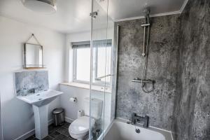 a bathroom with a shower toilet and a sink at The Sheiling in Tarbert