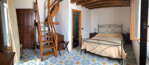 a bedroom with a bed and a wooden ladder at Hotel Villaggio Stromboli - isola di Stromboli in Stromboli