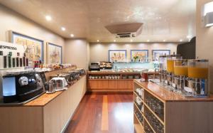 a kitchen with a counter with a coffee shop at Hotel MS Maestranza Málaga in Málaga