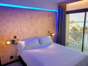 a bedroom with a bed and a large window at MB Hostels Premium ECO - Adults Recommended in Nerja