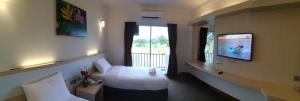 Sungai KechilSERDANG LAKE VIEW RESORT的配有床和电视的酒店房间