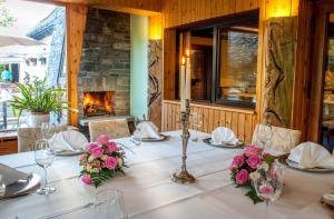 a table with flowers on it with a fireplace at Ferienhotel Augustusburg in Augustusburg