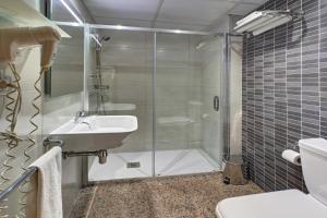a bathroom with a shower and a sink and a toilet at Hotel Nuevo Triunfo in Barcelona +45 photos