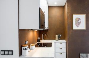 a bathroom with a sink and a mirror at Apartamenty Mielenko Wichrowe Wzgórze in Mielno +63 photos