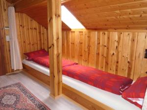 a log cabin with two beds in a room at Untermetzgersbauernhof Alpirsbach in Alpirsbach
