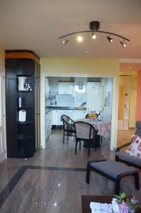 a living room and kitchen with a table and chairs at Apartamento Tere in Llanes