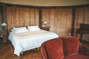 a bedroom with a large bed and wooden walls at "La Girelle, bord de mer" in Honfleur