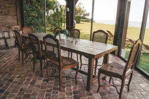 a wooden table and chairs on a patio at "La Girelle, bord de mer" in Honfleur +18 photos