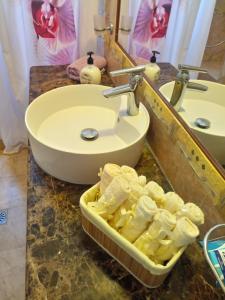 a bathroom with a sink and a tub of butter at Villa Christina Luxury in Vouliagmeni Lake