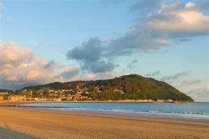 a beach with a view of the ocean and mountains at Stones Hotel and Bar in Minehead