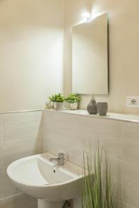 a white bathroom with a sink and a mirror at River View in Fiumicino