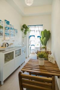 a kitchen with a wooden table and some potted plants at River View in Fiumicino