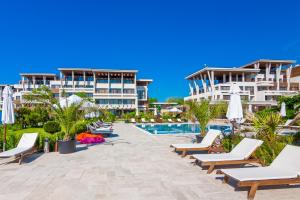 a resort with lounge chairs and a swimming pool at Apolonia Resort in Sozopol