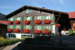 a building with flower boxes on the side of it at Ferienwohnung Baumgartner in Bad Hindelang