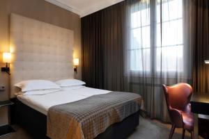 Postel nebo postele na pokoji v ubytování Elite Plaza Hotel