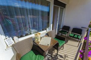 a balcony with a table and chairs and a window at Apartment Tihana in Stari Grad