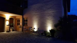 a building with lights on the side of it at night at Ferienwohnungen Renner in Viereth-Trunstadt