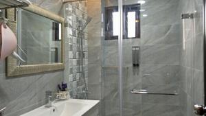 a bathroom with a shower and a sink and a mirror at Youngnn Hostel in Lukang +34 photos