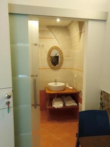 a bathroom with a sink and a mirror at la casetta in Favignana