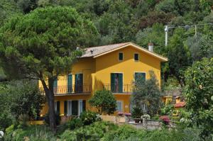 ein gelbes Haus an der Seite eines Hügels in der Unterkunft Agriturismo Costa di Campo in Vernazza