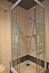 a shower stall with a glass shower door at ibis Styles Moulins Centre in Moulins