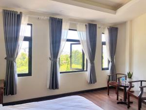 Postel nebo postele na pokoji v ubytování Le Grey Dalat Hotel