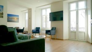 a living room with a couch and chairs and a table at La Casa sul Lago Lecco in Lecco