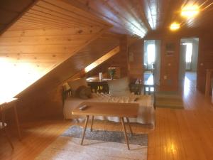 a room with a bed and a table in a attic at Farmholiday Kumpunen in Petäjävesi