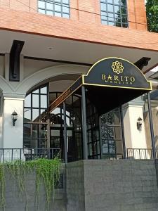 a restaurant with a sign on the front of a building at Barito Mansion in Jakarta