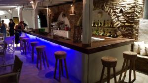 a bar with blue lighting in a restaurant at Tinos apartments Zalonis in Agios Ioannis