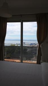 a bedroom with a bed and a view of the ocean at Apartaments Josep Pla in Roses